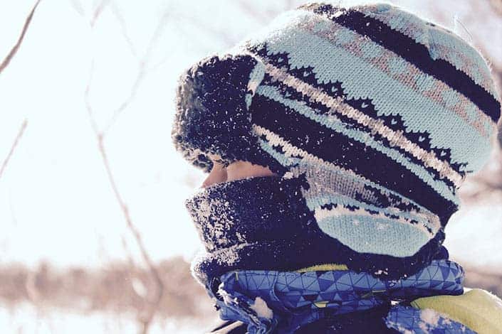 Girl wearing wooly hat in the snow