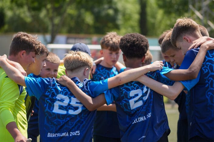 students group team hug football pitch students group team hug football pitch