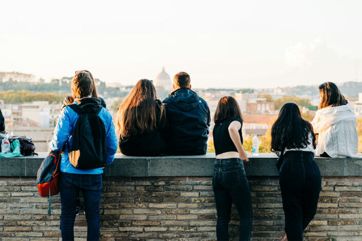 group of students sitting on wall enjoying the view group of students sitting on wall enjoying the view