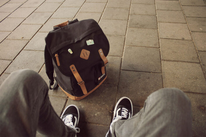 student with backpack at feet student with backpack at feet